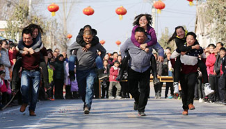 Wife-carrying contest held during celebrations in C China