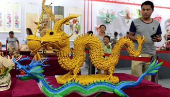 People view handicrafts at 4th China Intangible Cultural Heritage Expo in Jinan