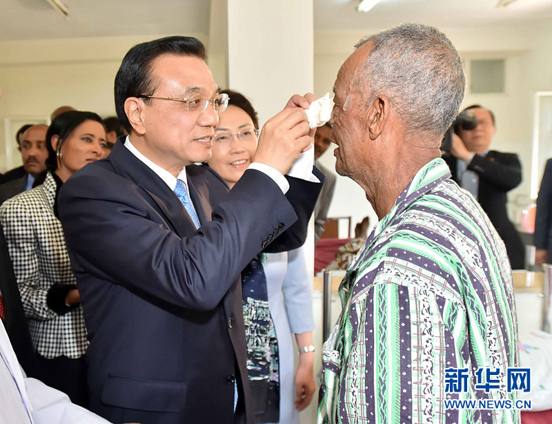 5月6日，国务院总理李克强与埃塞俄比亚总统穆拉图一同来到亚的斯亚贝巴阿勒塔医院，看望受益于中国免费白内障手术“光明行”活动的埃塞俄比亚患者。这是李克强亲手为接受中国医生手术的埃塞俄比亚白内障患者拆开纱布。 新华社记者 李涛 摄 